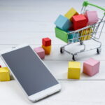 Mobile phone with shopping cart icon representing online digital product store and mobile shopping concept