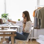Etsy Printables Shop. A lady sitting on table and viewing Etsy shop.