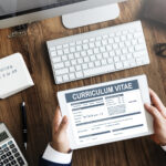 Curriculum Vitae and Resume on desk for LinkedIn profile and job application services