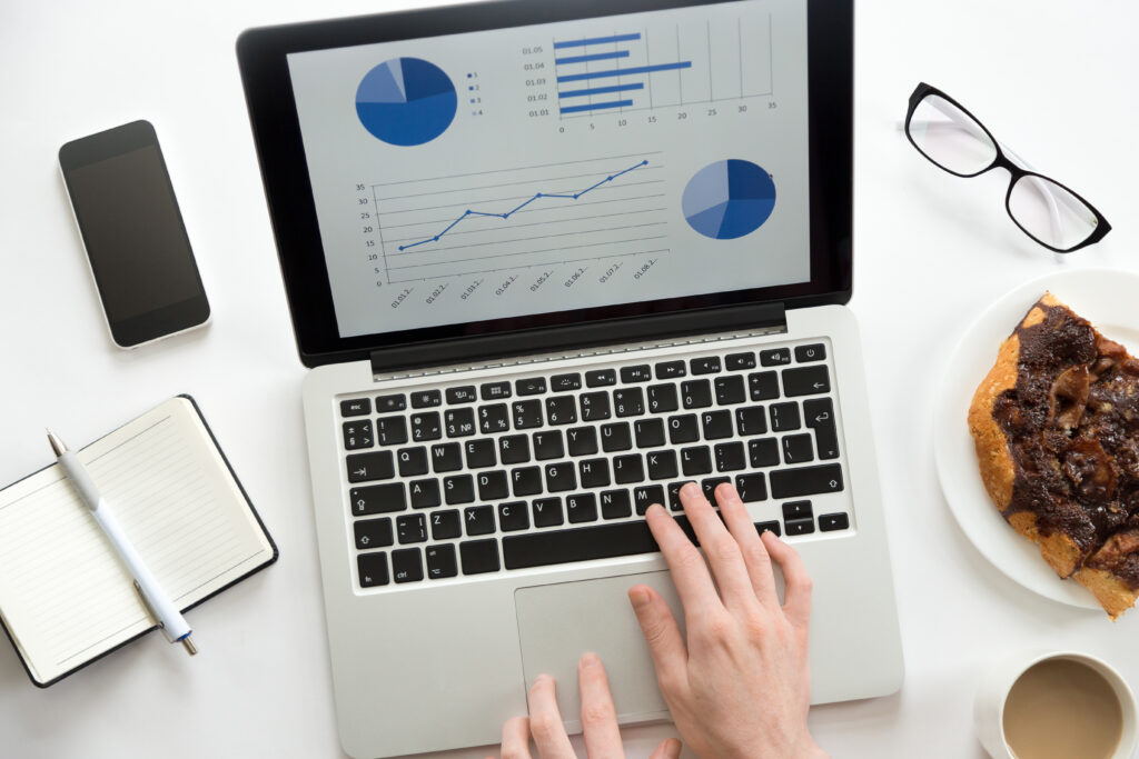 Person conducting market research for an online business idea on a laptop with a diagram.