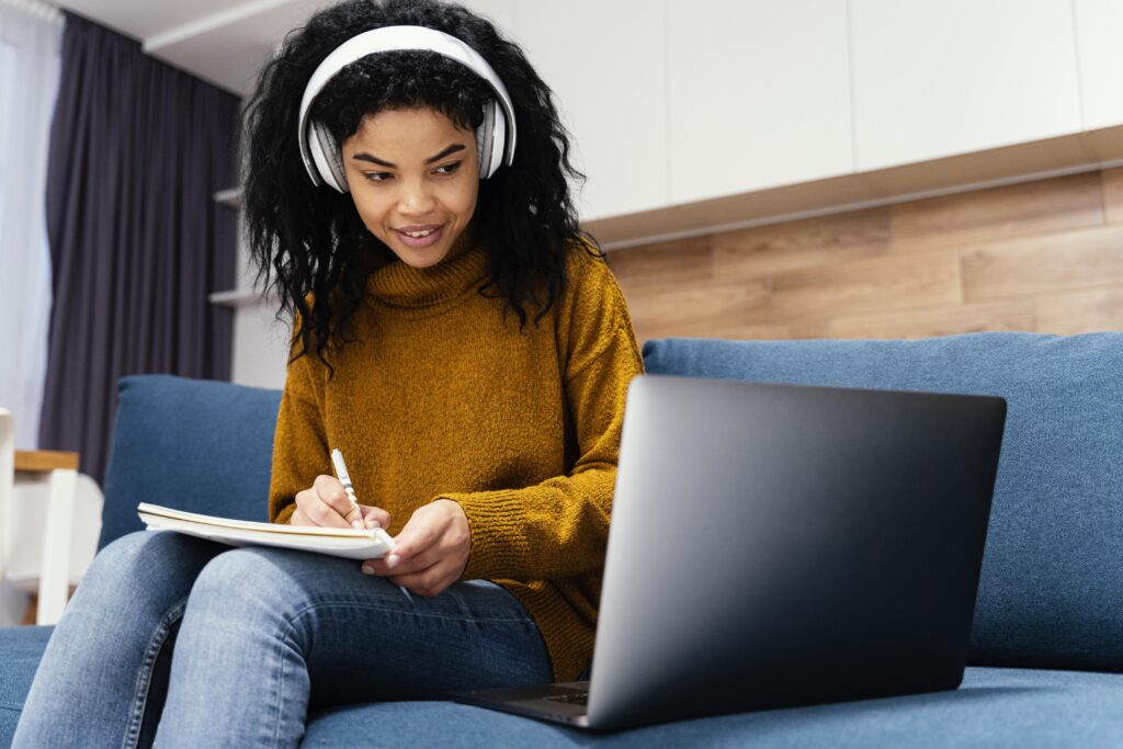 Smiling teenage girl wearing headphones learning online, ideal for transcription training and remote work
