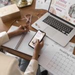 Event planner managing wedding details from a high angle, showcasing online event planning workflow.