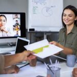 Online coaching session with multiple people using digital devices during a virtual meeting