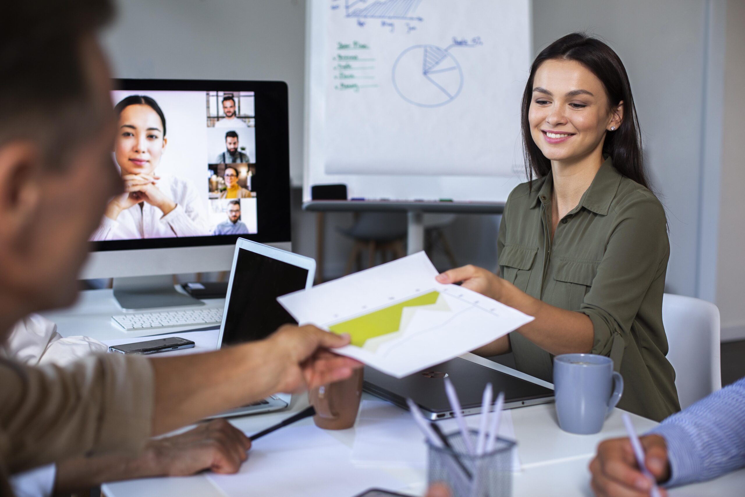 Online coaching session with multiple people using digital devices during a virtual meeting