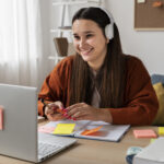 Virtual classroom setup with laptop, books, and study materials on a desk